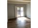 Bright living room with wood floors and sliding glass doors, providing access to a private balcony at 9725 E Harvard Ave # 346, Denver, CO 80231