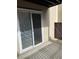 Outdoor patio with sliding glass doors, wall, and brown gate at 9725 E Harvard Ave # 346, Denver, CO 80231