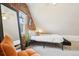 Inviting attic bedroom with brick accent wall, modern decor, and soft carpeting at 953 Kalamath St, Denver, CO 80204