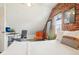 Charming attic bedroom with a unique brick wall, comfortable seating, and a minimalist design at 953 Kalamath St, Denver, CO 80204