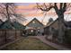 Charming backyard with lawn, patio set, hammock, and privacy fence at dusk at 953 Kalamath St, Denver, CO 80204