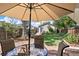 A serene backyard featuring a stone patio, mature trees, and privacy fencing, perfect for outdoor entertaining and relaxing at 953 Kalamath St, Denver, CO 80204