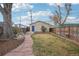 Backyard featuring a lush lawn, flagstone path, and a charming egg chair swing at 953 Kalamath St, Denver, CO 80204