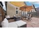 Inviting patio area with comfortable seating, a fire pit, an umbrella, and flagstone pavers at 953 Kalamath St, Denver, CO 80204