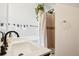 Bright bathroom with double sinks, decorative towels, and a tiled shower with plants at 953 Kalamath St, Denver, CO 80204