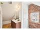 Bright bathroom with double sink vanity, exposed brick accent wall, and a window at 953 Kalamath St, Denver, CO 80204
