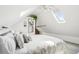Serene bedroom featuring sloped ceilings, skylights, and a charming brick wall, offering a cozy retreat at 953 Kalamath St, Denver, CO 80204