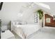 Bright bedroom features all-white décor, complemented by a brick accent wall and skylight at 953 Kalamath St, Denver, CO 80204