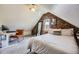 Bright bedroom with exposed brick, a cozy workspace, and a comfortable bed in a naturally lit space at 953 Kalamath St, Denver, CO 80204