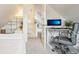 Charming bedroom with a bright office space, plush carpet, and built-in shelving for optimal storage at 953 Kalamath St, Denver, CO 80204