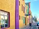 View of a bright yellow building with purple trim and signage for 'Event Gallery Coffee House' at 953 Kalamath St, Denver, CO 80204