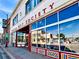 Street view of the Denver Art Society building with large windows and red and rainbow trim at 953 Kalamath St, Denver, CO 80204