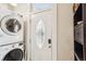 Entryway shows a white front door with decorative glass, adjacent to a stacked washer and dryer at 953 Kalamath St, Denver, CO 80204