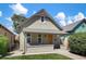 Charming bungalow-style home featuring a cozy front porch and fresh exterior paint with craftsman details and vibrant landscaping at 953 Kalamath St, Denver, CO 80204