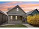 Charming bungalow-style home featuring a cozy front porch and fresh exterior paint with craftsman details and vibrant landscaping at 953 Kalamath St, Denver, CO 80204