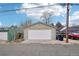 Detached two-car garage with a white door, featuring alley access at 953 Kalamath St, Denver, CO 80204