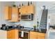 Well-organized kitchen with modern appliances, wood cabinets, and dark countertops at 953 Kalamath St, Denver, CO 80204