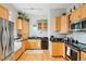 Functional kitchen featuring stainless appliances, wood cabinets, and sleek black countertops at 953 Kalamath St, Denver, CO 80204