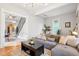 Comfortable living area with a large gray sectional and access to the staircase and kitchen at 953 Kalamath St, Denver, CO 80204
