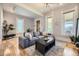 Bright living room features a comfortable gray sectional sofa, stylish lighting, and hardwood floors at 953 Kalamath St, Denver, CO 80204