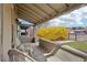 Relaxing front porch features classic railings and an inviting seating area, ideal for enjoying the neighborhood view at 953 Kalamath St, Denver, CO 80204