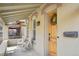 Welcoming front porch with charming seating, a wooden door with wreath, and updated fixtures, creating a cozy entrance at 953 Kalamath St, Denver, CO 80204