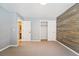Bedroom with wood accent wall, closet and neutral carpet at 2120 Pintail Dr, Longmont, CO 80504
