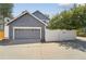 Attached garage with driveway and partial fence surrounding property at 2120 Pintail Dr, Longmont, CO 80504