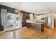 Modern kitchen featuring stainless steel appliances, an island, and an adjacent dining area with backyard access at 2120 Pintail Dr, Longmont, CO 80504