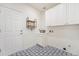 Functional laundry room with ample storage, patterned floors, and utility sink at 2120 Pintail Dr, Longmont, CO 80504