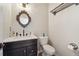 Stylish powder room features a marble countertop, elegant mirror, and updated fixtures at 2120 Pintail Dr, Longmont, CO 80504