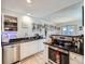 Well-lit kitchen features stainless steel appliances, granite countertops, and tile flooring at 1057 Delta Dr # A, Lafayette, CO 80026