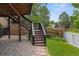 Backyard featuring a wooden deck with stairs leading to a landscaped yard, perfect for outdoor entertaining and relaxation at 12277 W Chenango Dr, Morrison, CO 80465