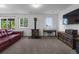 Finished basement space with piano, wood burning stove, and entertainment center at 12277 W Chenango Dr, Morrison, CO 80465