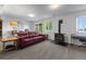 Cozy finished basement featuring a couch, piano, and wood-burning stove at 12277 W Chenango Dr, Morrison, CO 80465