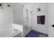 Well-lit bathroom features a shower with glass door and soaking tub at 12277 W Chenango Dr, Morrison, CO 80465