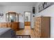 Bright bedroom with wood floors and dressers, leading to a bathroom at 12277 W Chenango Dr, Morrison, CO 80465