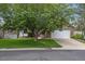 Charming home featuring a stone-accented two-car garage and a well-manicured front yard with mature trees at 12277 W Chenango Dr, Morrison, CO 80465
