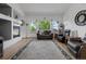 Spacious living room featuring a fireplace, large windows, hardwood floors, and comfortable seating at 12277 W Chenango Dr, Morrison, CO 80465