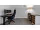 Bright office space with dual monitors, ergonomic chair, and a traditional wooden desk with a lamp, offering ample workspace at 12277 W Chenango Dr, Morrison, CO 80465