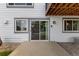 The back of the house with sliding glass doors, and a concrete patio, blending indoor and outdoor living spaces seamlessly at 12277 W Chenango Dr, Morrison, CO 80465