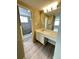 Bathroom features an updated shower, sink with vanity, light fixture and large mirror at 8828 E Florida # 113, Denver, CO 80247