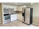 Updated kitchen featuring white cabinets, stainless appliances, and gray backsplash at 8828 E Florida # 113, Denver, CO 80247