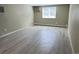 Spacious room with light gray flooring, window with blinds, and neutral paint at 8828 E Florida # 113, Denver, CO 80247