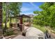 Landscaped backyard with patio featuring outdoor kitchen, pergola, and lounge seating at 21962 E Idyllwilde Dr, Parker, CO 80138