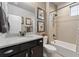 Bathroom with granite vanity, shower over tub, and neutral wall tile at 21962 E Idyllwilde Dr, Parker, CO 80138