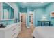 Bright bedroom featuring blue walls, white furniture, and neutral carpeting at 21962 E Idyllwilde Dr, Parker, CO 80138