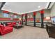 Finished bonus room with red sofa, gray walls, and red and black accents at 21962 E Idyllwilde Dr, Parker, CO 80138