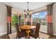 Cozy dining area with a round wooden table, wicker chairs, and large windows at 21962 E Idyllwilde Dr, Parker, CO 80138