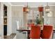 Elegant dining room featuring wood table, stylish chairs, and modern lighting fixtures at 21962 E Idyllwilde Dr, Parker, CO 80138